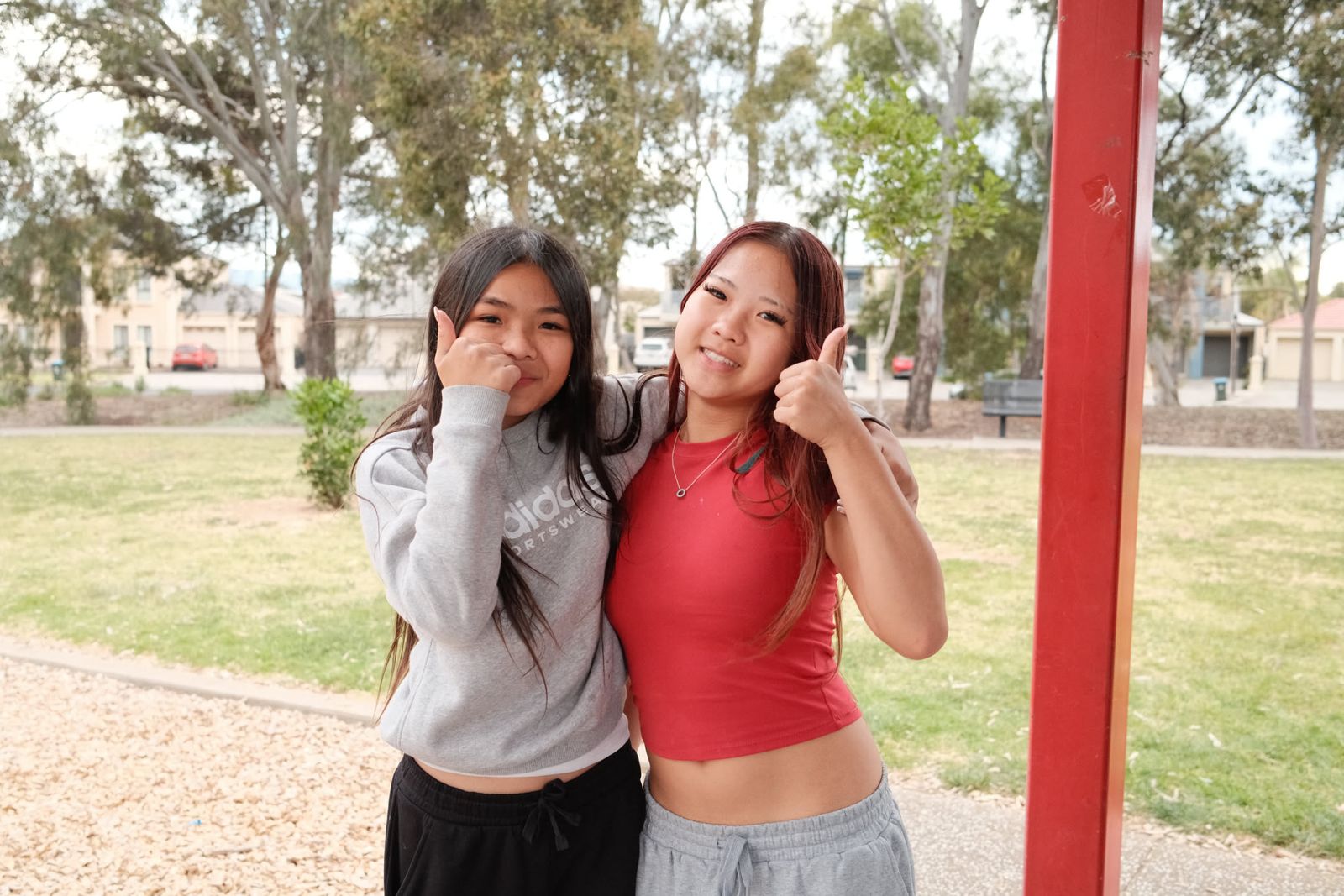 Two friends smiling together at the park